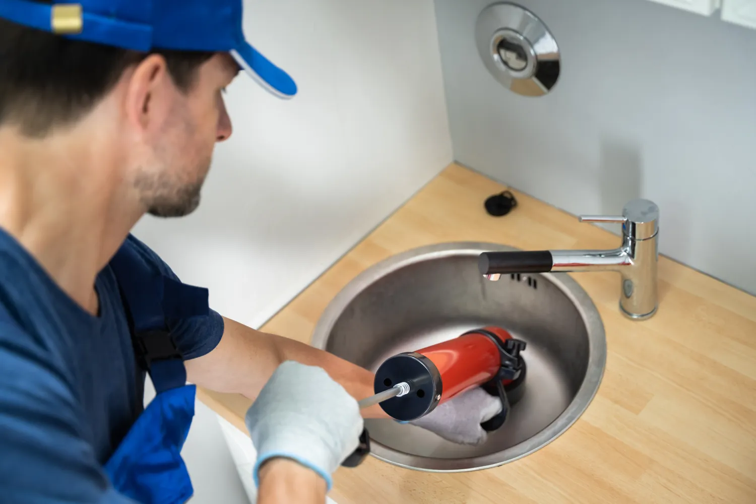 Licensed plumber performing on-site plumbing work