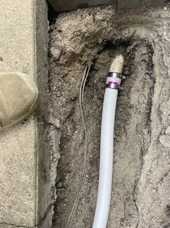 Professional plumber detecting and fixing water pipe leaks